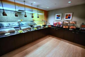 a restaurant kitchen with a counter with food at Hilton Garden Inn Bethesda Downtown in Bethesda
