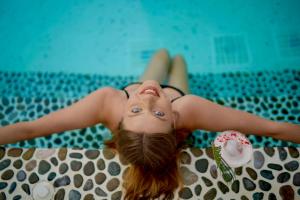 a girl in a bikini laying in a swimming pool at Kassandra Boutique Hotel in Oludeniz