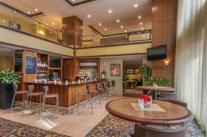 a hotel lobby with a bar and stools at Hilton Garden Inn Bethesda Downtown in Bethesda