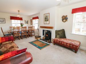 a living room with a couch and a fireplace at Larch House in Penrith