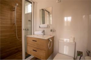 a bathroom with a sink and a toilet and a shower at Aparthotel Madeleine in Antananarivo