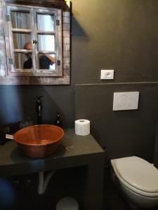 a bathroom with a sink and a toilet and a window at Casale Orgogliosa in San Vito Chietino