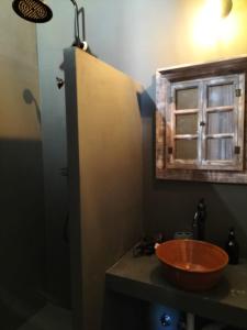 a bathroom with a wooden sink and a window at Casale Orgogliosa in San Vito Chietino