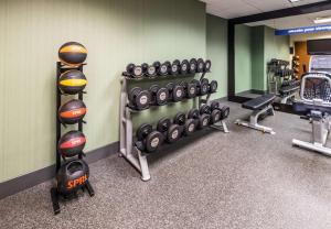 a gym with several rows of dumbbells and weights at Hampton Inn Waterville in Waterville