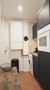 a kitchen with a stove and a washer and dryer at Loft Place Massena in Nice