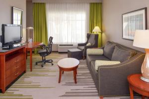 a living room with a couch and a tv at Hilton Garden Inn Yuma Pivot Point in Yuma