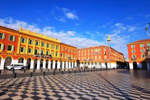 a group of buildings on a street with a blue sky at Loft Place Massena in Nice