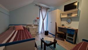 a small bedroom with a bed and a desk at Room "Iva" in Josipdol