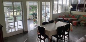 a dining room with a table and chairs and a couch at Pelican's Reach in Pedro Pen