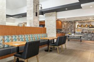 a restaurant with two tables and two chairs at Hilton Garden Inn Kitchener/Cambridge in Cambridge