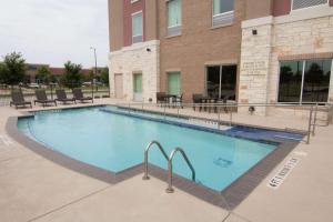 a large swimming pool in front of a building at Hampton Inn & Suites Dallas/Frisco North-Fieldhouse USA in Frisco