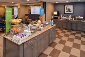 a breakfast buffet in a hotel room with fruit on a counter at Hampton Inn Broussard-Lafayette in Broussard