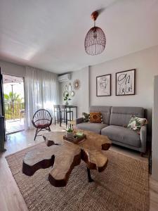 uma sala de estar com uma mesa de centro e um sofá em Suite Bonalba em Alicante
