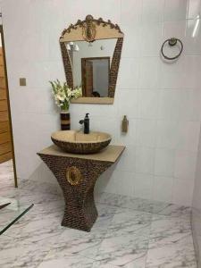 a bathroom with a sink and a mirror at *NEW BUILD* Luxury Holiday Home in Sylhet