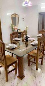a dining room with a table with chairs and a tableasteryasteryasteryasteryastery at *NEW BUILD* Luxury Holiday Home in Sylhet