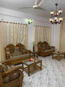 a living room with couches and tables at *NEW BUILD* Luxury Holiday Home in Sylhet