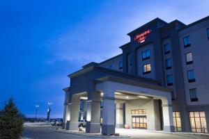 a hotel with a sign on the front of it at Hampton Inn by Hilton Lloydminster in Lloydminster