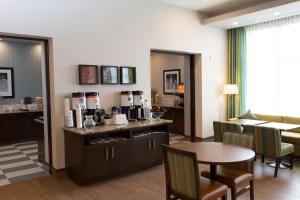 a living room with a table and a coffee station at Hampton Inn by Hilton Lloydminster in Lloydminster