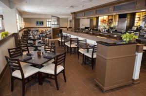 a restaurant with tables and chairs and a bar at DoubleTree by Hilton Boston/Westborough in Westborough