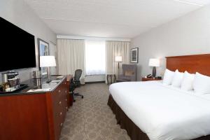 a hotel room with a large bed and a flat screen tv at DoubleTree by Hilton Boston/Westborough in Westborough
