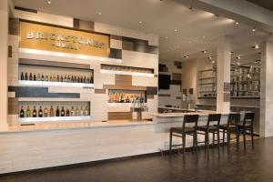 a bar in a restaurant with bar stools at Embassy Suites by Hilton Chicago Naperville in Naperville