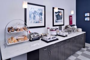 a kitchen with a counter with a bunch of pastries at Hampton Inn & Suites Shelby, North Carolina in Shelby