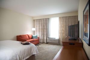 a hotel room with a bed and a television at Hampton Inn and Suites by Hilton McKinney in McKinney