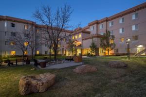 a courtyard with rocks in front of a building at Homewood Suites by Hilton Denver West - Lakewood in Lakewood