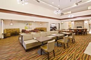 a hotel lobby with couches and tables and chairs at Homewood Suites by Hilton Denver West - Lakewood in Lakewood