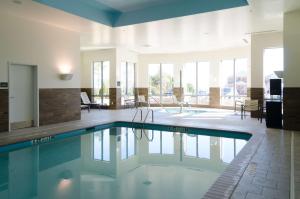 a large swimming pool in a room with a large window at Hilton Garden Inn Hickory in Hickory