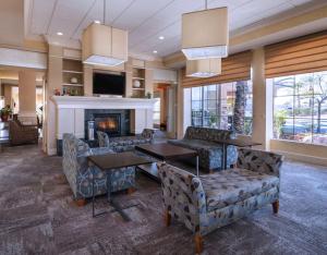 a living room with couches and a fireplace at Hilton Garden Inn Las Vegas Strip South in Las Vegas