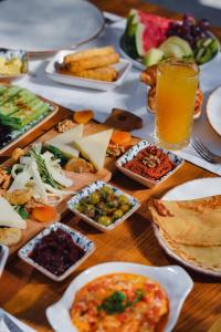 a table topped with plates of food and drinks at Kassandra Boutique Hotel in Oludeniz