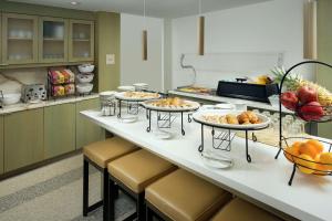 a kitchen with three plates of food on a counter at Hilton Garden Inn Miami South Beach in Miami Beach