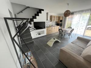 a living room with a staircase leading up to a kitchen at la vallées du tuffeau in Bourré