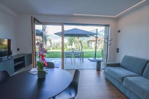 a living room with a table and a couch at Olivo Luxury Apartments in Malcesine