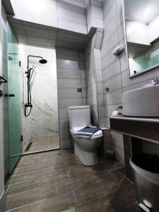 a bathroom with a shower and a toilet and a sink at Villa Riviera in Stavros