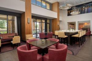 a dining room with red chairs and a table at Hampton Inn & Suites Phoenix/Tempe in Tempe