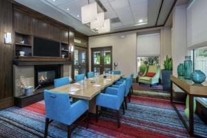 a conference room with a table and chairs and a fireplace at Hilton Garden Inn San Antonio/Rim Pass Drive in San Antonio