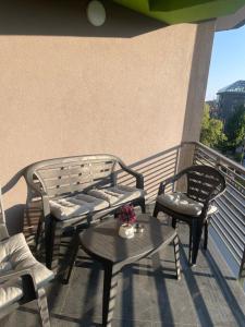 a balcony with two chairs and a bench and a table at R&B Apartment City Center in Ohrid