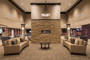 a lobby with couches and a stone fireplace at DoubleTree by Hilton Schenectady in Schenectady