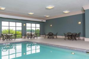 a pool with tables and chairs in a room with at Hampton Inn Warsaw in Warsaw