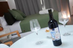 a bottle of wine sitting on a table with two wine glasses at Casa14 in La Plata