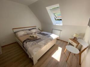 a small bedroom with a bed and a window at Penzion U Adama in Karlštejn