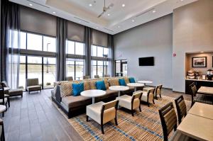 a lobby with a couch and tables and chairs at Homewood Suites by Hilton Cincinnati/West Chester in West Chester