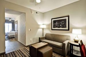 a living room with a couch and a bed at Homewood Suites by Hilton Cincinnati/West Chester in West Chester