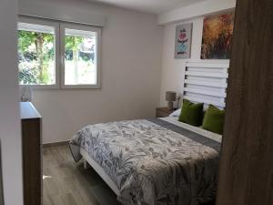 a white bedroom with a bed with green pillows at CASA MAR DE LUNA Playas en Raxo in Raxo
