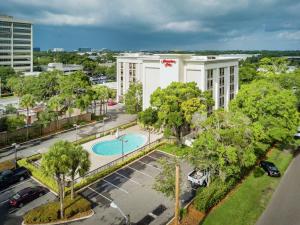 an aerial view of a building with a pool at Hampton Inn Tampa International Airport/Westshore in Tampa