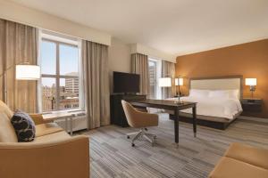 a hotel room with a bed and a desk with a computer at Hampton Inn & Suites - Roanoke-Downtown, VA in Roanoke