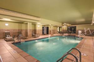 a large pool in a hotel with tables and chairs at Homewood Suites by Hilton Ankeny in Ankeny