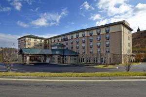 a large building with a parking lot in front of it at Hilton Garden Inn Roanoke in Roanoke